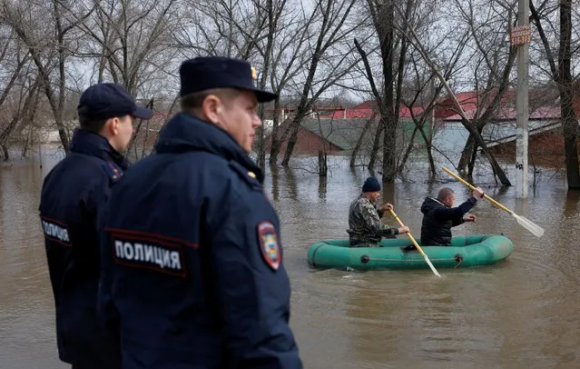 People sail an inflatable boat through a flooded residential area in Orenburg, Russia, on April 12, 2024. (Photo by Maxim Shemetov/Reuters)