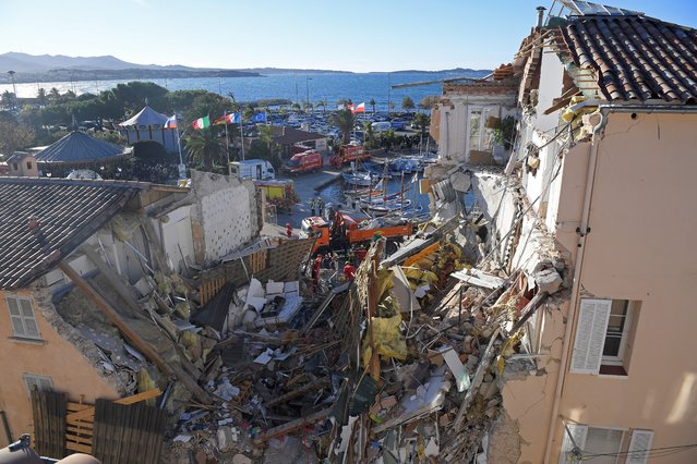 French firefighters search the rubble for missing inhabitants after a building collapsed in Sanary-sur-Mer, on December 7, 2021. Five people are “probably trapped in the rubble” of a three-story apartment building that collapsed overnight in Sanary-sur-Mer, Var, following an explosion that may have been caused by a gas problem, according to the firefighters. (Photo by Nicolas Tucat/AFP Photo)