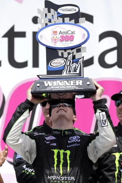 Erik Jones holds up the trophy in Victory Lane after winning the NASCAR Xfinity series auto race at Chicagoland Speedway, Sunday, June 21, 2015, in Joliet, Ill. (AP Photo/Nam Y. Huh) 