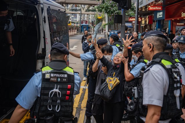 Alexandra Wong (C, white hair), an activist known as Grandma Wong, is led to a police van after being detained by police officers at Causeway Bay near Victoria Park in Hong Kong, China, 04 June 2024. For almost three decades, people in Hong Kong commemorated the 04 June anniversary of China's deadly crackdown on protesters in Tiananmen Square with a noisy candlelit vigil in the city's Victoria Park. Now the subject is so sensitive, that nearby Victoria Park had been the site of an annual remembrance of the crackdown at Tiananmen Square, the event has no longer taken place since the new national security law came into effect. (Photo by Leung Man Hei/EPA)