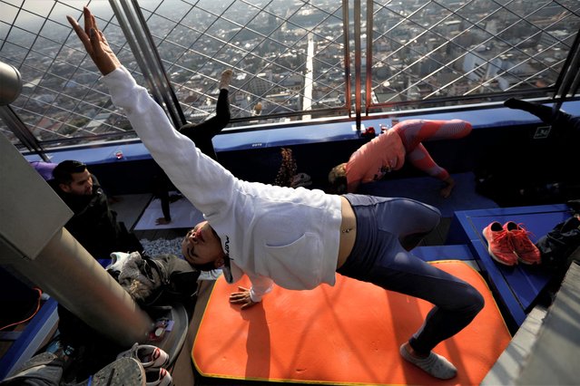 Yoga enthusiasts participate in a yoga class to welcome the Spring Equinox at the Torre Latinoamericana viewpoint, in Mexico City, Mexico on March 18, 2023. (Photo by Luis Cortes/Reuters)