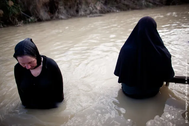Orthodox Christian pilgrims are baptized during Epiphany celebrations in the Jordan River