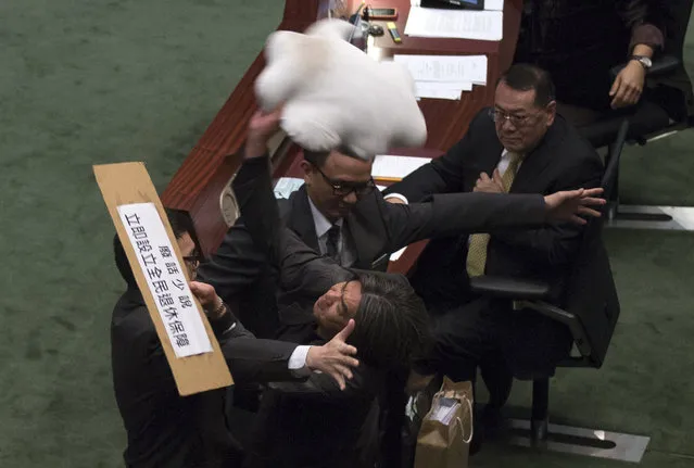 Pro-democracy lawmaker Leung Kwok-hung throws a cloud-shaped cushion at Hong Kong's Financial Secretary John Tsang to demand a universal retirement protection scheme during the annual budget report at the Legislative Council in Hong Kong, February 27, 2013. The sign reads “No more nonsense. Set up universal retirement protection scheme now”. (Photo by Tyrone Siu/Reuters)