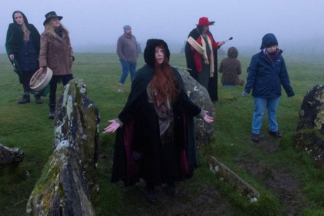 Revellers celebrate the arrival of Spring Equinox on top of Sliabh na Caillaigh at dawn to watch the sunrise during bad weather over the ancient Loughcrew megalithic cairns, in Oldcastle, Ireland, on March 20, 2024. (Photo by Clodagh Kilcoyne/Reuters)