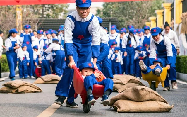 A parent carries a kid using a cart during the parent-child sports games in a kingdergarten in Ji'an city, east China's Jiangxi province, 6 November 2019. (Photo by Imaginechina via AP Images)