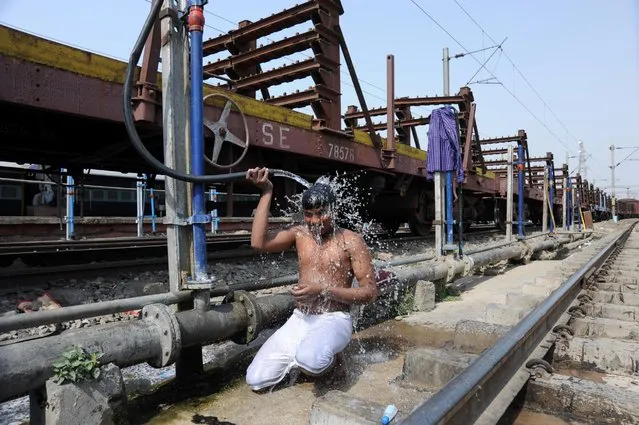 A commuter cools off at Allahabad railway junction on May 14, 2016. Much of India is reeling from a heat wave and severe drought conditions. (Photo by Prabhat Kumar/Getty Images)