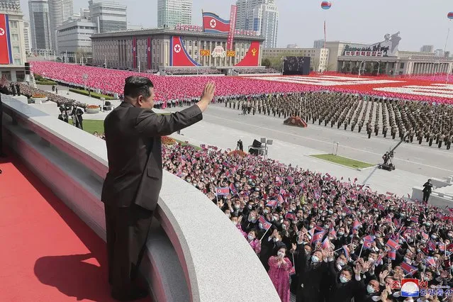 In this photo provided by the North Korean government, North Korean leader Kim Jong Un waves from balcony as he attends a parade to celebrate the 110th birth anniversary of its late founder Kim Il Sung, at the Kim Il Sung Square in Pyongyang, North Korea Friday, April 15, 2022. Independent journalists were not given access to cover the event depicted in this image distributed by the North Korean government. The content of this image is as provided and cannot be independently verified. Korean language watermark on image as provided by source reads: “KCNA” which is the abbreviation for Korean Central News Agency. (Photo by Korean Central News Agency/Korea News Service via AP Photo)