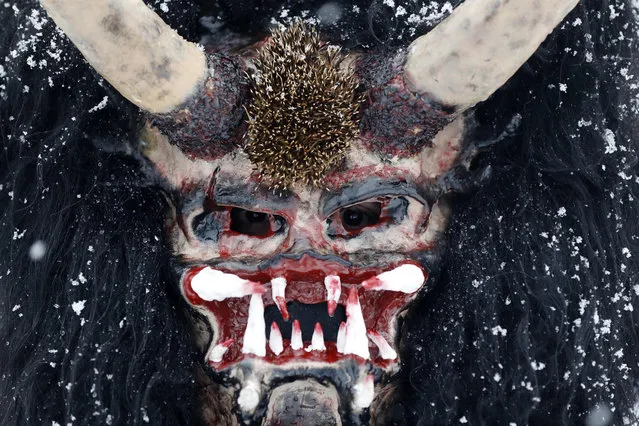 Reveler depicting devil poses for a photo during a traditional St Nicholas procession in the village of Valasska Polanka, Czech Republic, Saturday, December 7, 2019. (Photo by Petr David Josek/AP Photo)