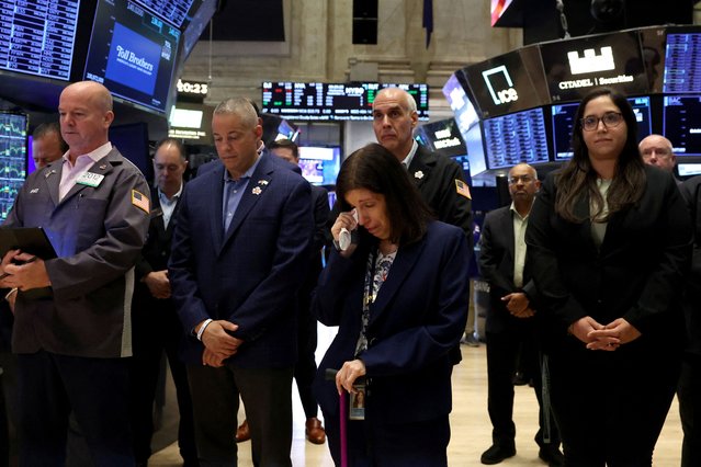 Traders and employees pause during a moment of silence, on the 23rd anniversary of the September 11, 2001 attacks, on the floor at the New York Stock Exchange, in New York City, U.S., September 11, 2024. (Photo by Brendan McDermid/Reuters)