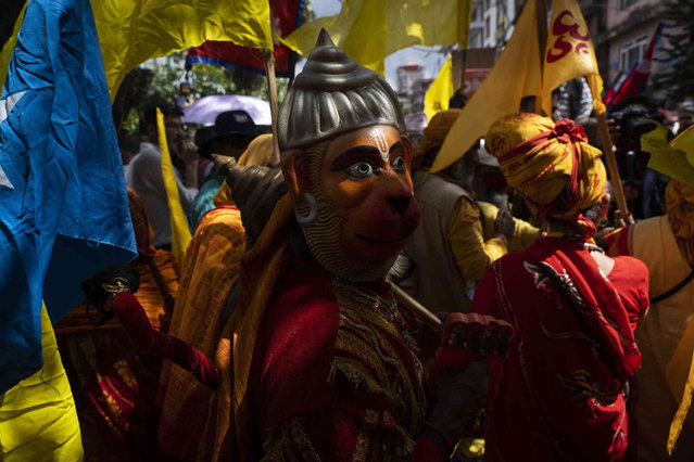 A holy man dressed as a Hanuman, Hindu god, participates in a protest against secularism, demanding the reinstatement of Nepal as a Hindu state and the restoration of the monarchy near parliament building in Kathmandu, Nepal, Friday, September 13, 2024. (Photo by Niranjan Shrestha/AP Photo)