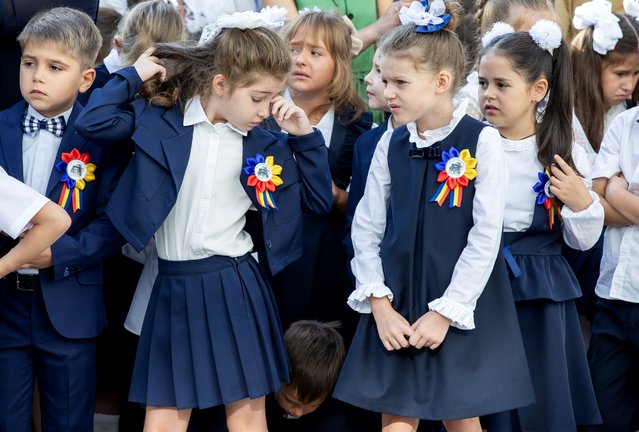 A little girl rubs her tired eyes during the first day at the lyceum named after Moldovan writer Gheorghe Asachi in Chisinau on September 2, 2024. (Photo by Dumitru Doru/Radio Free Europe/Radio Liberty)