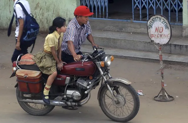 A Naga girl sits on a bike as she leaves after attending school in Dimapur, in India's north-eastern state of Nagaland, Tuesday, August 4, 2015. India's government signed a peace treaty on Monday with Thuingaleng Muivah, leader of the Isak-Muivah faction of the National Socialist Council of Nagaland, in the presence of Prime Minister Narendra Modi aimed at ending a rebellion that has festered in India's Nagaland and Manipur states for more than six decades. (Photo by Sorei Mahong/AP Photo)