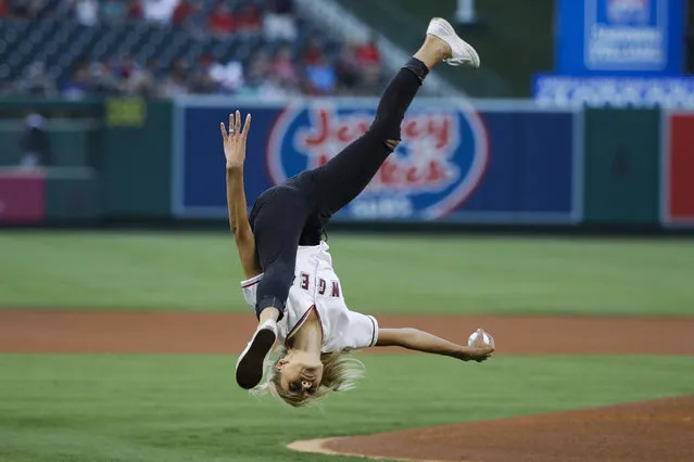 Former Olympic gymnast Nastia Liukin performs a flip while throwing the ceremonial first pitch during a baseball game between the Los Angeles Angels and the Tampa Bay Rays, Friday, July 14, 2017, in Anaheim, Calif. (Photo by Jae C. Hong/AP Photo)