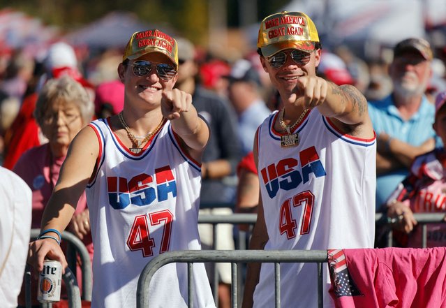 Supporters of Republican presidential nominee and former U.S. President Donald Trump point at photographers while waiting in line outside the venue for his campaign rally, in Greensboro, North Carolina on October 22, 2024. (Photo by Jonathan Drake/Reuters)