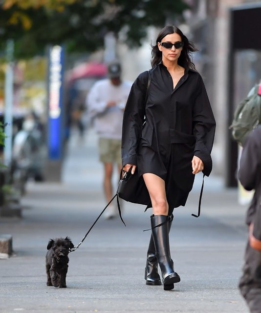 Irina Shayk is spotted out for a dog walk in New York City on October 22, 2024. The Russian supermodel wore a little black dress paired with knee high black boots. (Photo by The Image Direct)