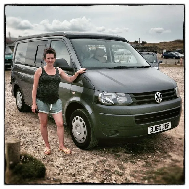 Nicola Rousseau from Surrey poses for a photograph besides her 2010 fifth generation T5, Volkswagen Transporter van near Newquay on August 8, 2014 in Cornwall, England. The van, which was converted to a camper van this year is normally on hire through Nicola's company Littlefoot Campers. (Photo by Matt Cardy/Getty Images)