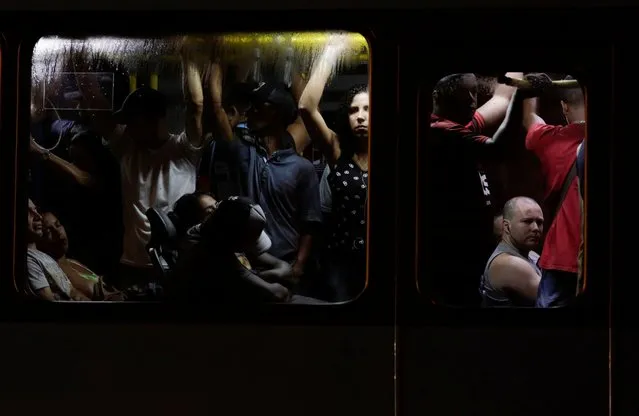 Passengers are pictured inside a public bus during the outbreak of the coronavirus disease (COVID-19) in Rio de Janeiro, Brazil, March 18, 2020. (Photo by Ricardo Moraes/Reuters)