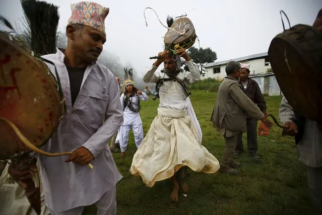 Shamans perform religious rituals during the “Janai Purnima” festival (Sacred Thread Festival) at Timal Village in Kavre, Nepal August 29, 2015. Hindus in Nepal celebrate the festival for protection and purification. (Photo by Navesh Chitrakar/Reuters)