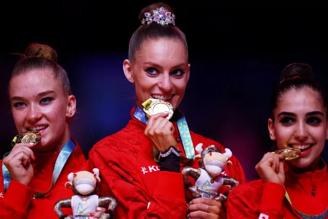 Canada's Carmel Kallemaa (centre) celebrates on the podium with her team-mates Tatiana Cocsanova (right) and Suzanna Shahbazian after they won gold in Rhythmic Gymnastics, Team Final and Individual Qualification – Sub Division 2 at Arena Birmingham on day seven of the 2022 Commonwealth Games in Birmingham on Thursday, August 4, 2022. (Photo by Hannah Mckay/Reuters)