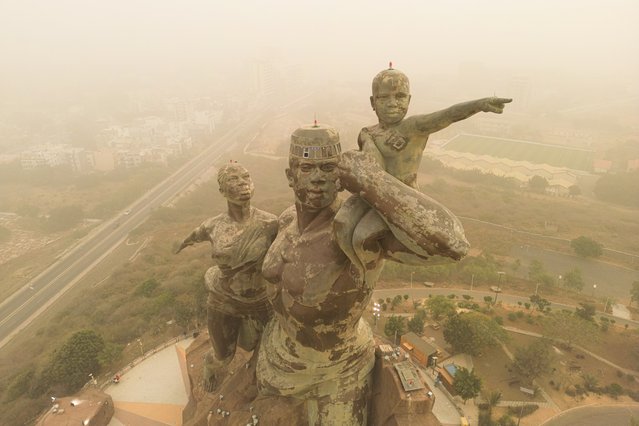 An. aerial view of dust clouds from the Sahara Desert covering the sky over Dakar, the capital of Senegal, shows streets and avenues shrouded in dust as visibility drops below 500 meters across the city on December 18, 2024. (Photo by Cem Ozdel/Anadolu via Getty Images)