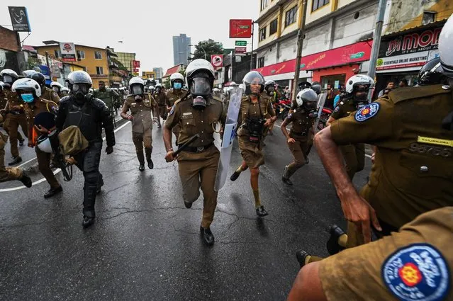 Policemen charge as university students and demonstrators protest against the Sri Lankan government and for the release of student leaders in Colombo on August 30, 2022. (Photo by Ishara S. Kodikara/AFP Photo)