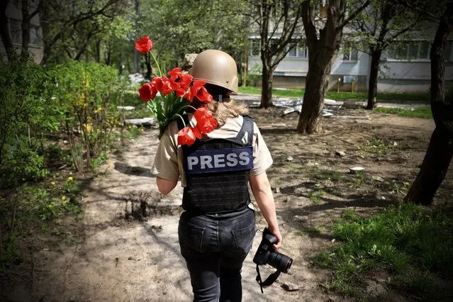 Ukrainian journalist Anna Reznik who was handed flowers at the front line by a random soldier in Saltivka, Ukraine on April 26, 2022. (Photo by Peter Jordan/The Sun)