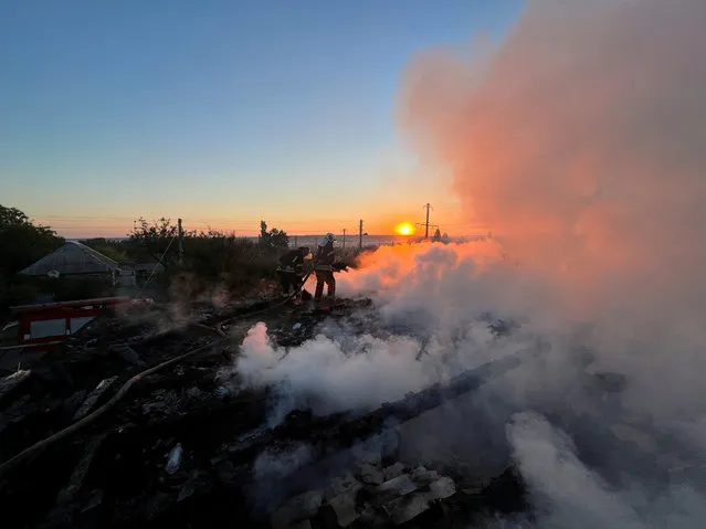 Ukrainian firefighters put out fire in a residential house after a Russian military strike, as Russia's attack in Ukraine continues, in Bakhmut, Donetsk region, Ukraine on September 5, 2022. (Photo by Alex Babenko/Reuters)