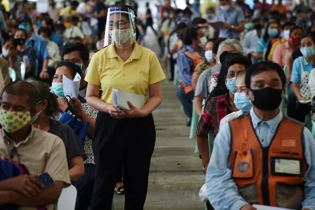 People wearing a protective face mask wait to file complaints for not yet receiving the 5,000 Thai baht (150 USD) financial assistance for those whose income is impacted by the COVID-19 coronavirus outbreak, in Bangkok, Thailand 08, May 2020. (Photo by Anusak Laowilas/NurPhoto via Getty Images)