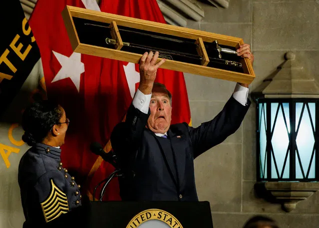 First Captain of West Point's Corps of Cadets presents Former U.S. President George W. Bush with a Cadets' Sword as he is honored with the Sylvanus Thayer Award at the United States Military Academy in West Point, New York, U.S., October 19, 2017. (Photo by Brendan McDermid/Reuters)
