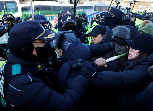 Impeached South Korean President Yoon Suk Yeol's supporters scuffle with police officers as authorities seek to execute an arrest warrant, in Seoul, South Korea, on January 15, 2025. (Photo by Tyrone Siu/Reuters)