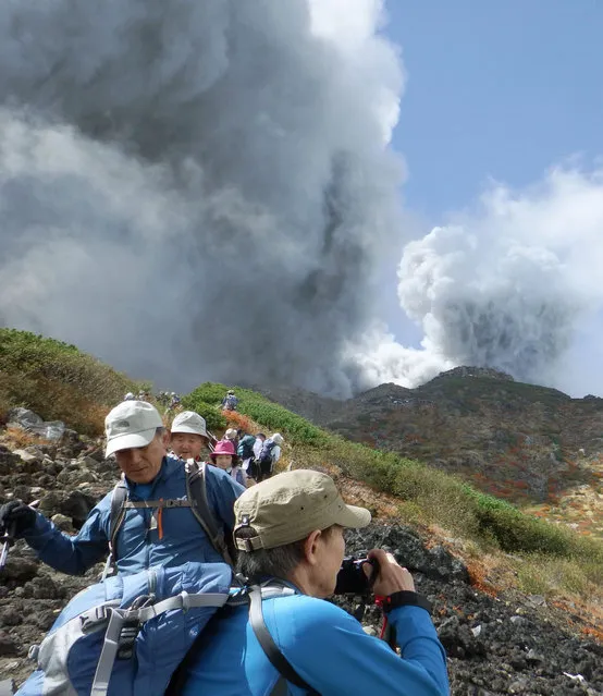 In this photo taken by an anonymous climber and was offered to Kyodo News, climbers descend Mt. Ontake to flee as the volcanic moutain erupts in central Japan, Saturday, September 27, 2014. (Photo by AP Photo/Kyodo News)