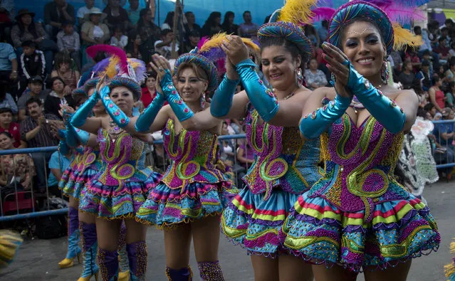 Members of the Morenada dance troupe perform during an annual parade in honor for the religious celebration, “Fiesta Virgin of Urkupina” in Quillacollo, Bolivia, Sunday August 14, 2016. Thousands of dancers and faithful gather every August, parade of dancers, and religious processions, to show their devotion to the Virgin. (Photo by Juan Karita/AP Photo)