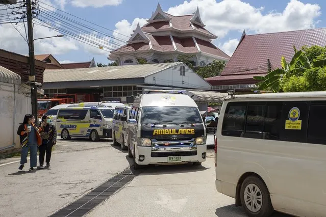 Following autopsies at the Udon Thani Hospital in Udon Thani, a line of ambulances carry the bodies of the victims in the Thursday day care attack back to their families waiting in neighboring Uthai Sawan, north eastern Thailand, Friday, October 7, 2022. (Photo by Wason Wanichakorn/AP Photo)