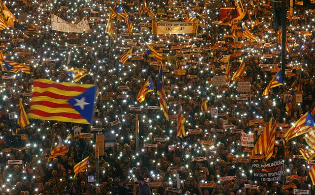 Protesters hold the lights of their mobile phones as they wave Estelada flags during a demonstration called by pro-independence associations asking for the release of jailed Catalan activists and leaders, in Barcelona, Spain, November 11, 2017. (Photo by Albert Gea/Reuters)
