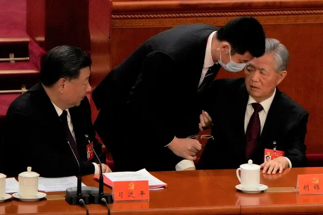 Chinese President Xi Jinping at left looks on as former Chinese President Hu Jintao is assisted to leave the hall during the closing ceremony of the 20th National Congress of China's ruling Communist Party at the Great Hall of the People in Beijing, Saturday, October 22, 2022. Former Chinese President Hu Jintao, Xi's predecessor as party leader, was helped off the stage shortly after foreign media came in, sparking speculation about his health. (Photo by Ng Han Guan/AP Photo)