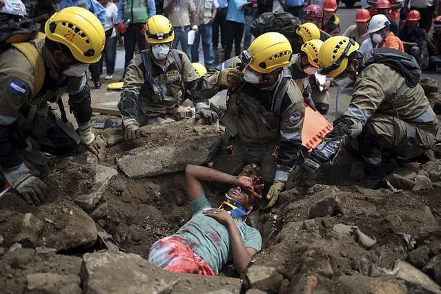 A boy role-playing an injured person is attended to by firefighters volunteer  during an earthquake drill in Managua,Nicaragua September 22,2015. (Photo by Oswaldo Rivas/Reuters)