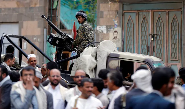 A Houthi militant mans a machine gun mounted on a patrol truck as he secures a vigil marking the anniversary of a double bomb attack inside a mosque during prayers that killed dozens of worshippers in Sanaa, Yemen, September 2, 2016. (Photo by Khaled Abdullah/Reuters)
