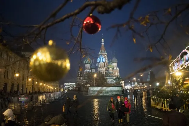 New Year and Christmas celebrations, with St. Basil Cathedral in the background, in Moscow, Russia, Monday, December 18, 2017. (Photo by Pavel Golovkin/AP Photo)