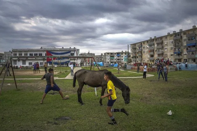 Children play ball in La Coloma, Pinar del Rio province, Cuba, Wednesday, October 5, 2022  (Photo by Ramon Espinosa/AP Photo)