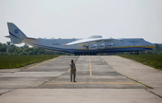 An Antonov An-225 Mriya, a cargo plane which is the world's biggest aircraft, is seen on an airfield before its first commercial flight to the Australian city of Perth in the settlement of Hostomel outside Kiev, Ukraine, May 10, 2016. (Photo by Valentyn Ogirenko/Reuters)