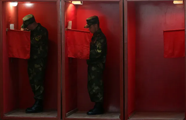 Servicemen vote in voting booths at a polling station during an early voting in the 2020 Belarusian presidential election which is held on 4-8 August in Minsk, Belarus on August 4, 2020. The 2020 Belarusian presidential election is scheduled for 9 August. (Photo by Natalia Fedosenko/TASS)