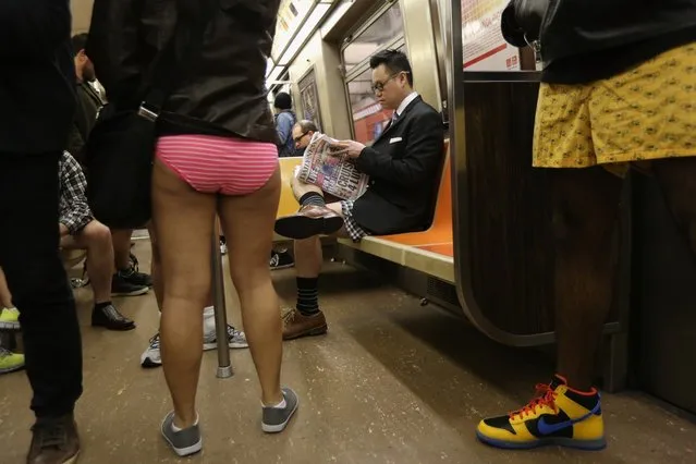 NEW YORK, NY - JANUARY 13:  People ride the subway pantless on January 13, 2013 in New York City. Thousands of people participated in the 12th annual No Pants Subway Ride, organized by New York City prank collective Improv Everywhere. During the afternoon winter event, participants boarded separate subway stops and removed their pants, pretending that they did not know each other. The event, refered to as a "celebration of silliness" is designed to make fellow subway riders laugh and smile.  (Photo by John Moore/Getty Images)