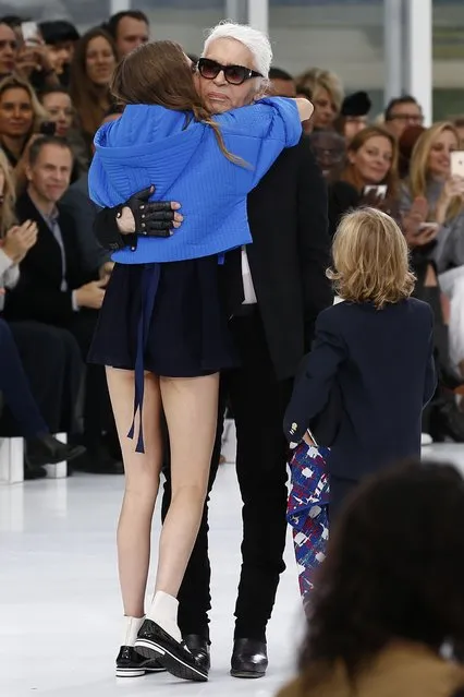 German designer Karl Lagerfeld (R) embraces model Cara Delevingne at the end of his Spring/Summer 2016 women's ready-to-wear collection fashion house Chanel at the Grand Palais which is transformed into a Chanel airport during Fashion Week in Paris, France, October 6, 2015. (Photo by Benoit Tessier/Reuters)