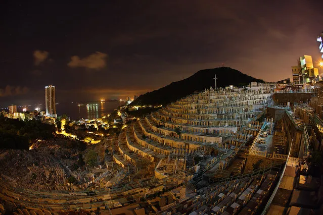 “Dead quiet”. It's well past mid night and this densely packed neighborhood is dead quiet. It's one of the largest Christian cemetery in Hong Kong. In Hong Kong land is scarce, when you're alive you live in tiny little pigeon holes, when you're dead, it doesn't get much better. Photo location: Hong Kong. (Photo and caption by Brian Yen/National Geographic Photo Contest)