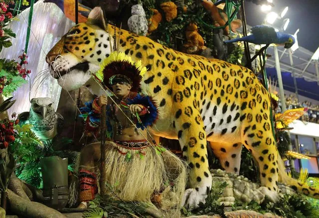 A reveller from Imperatriz Leopoldinense samba school participates during the annual Carnival parade in Rio de Janeiro's Sambadrome, February 12, 2013. (Photo by Sergio Moraes/Reuters)