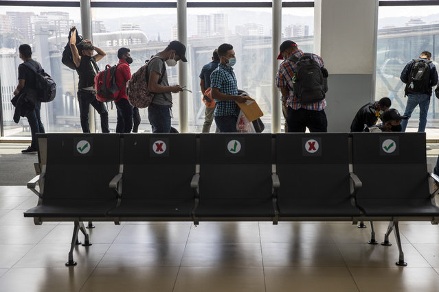 Passengers wait to board a humanitarian flight to Canada at the La Aurora international airport in Guatemala City, Thursday, September 17, 2020. Authorities are preparing for the reopening of the airport on Friday as part of the gradual reopening of the country's borders by allowing national flights and some duly authorized international flights. (Photo by Moises Castillo/AP Photo)