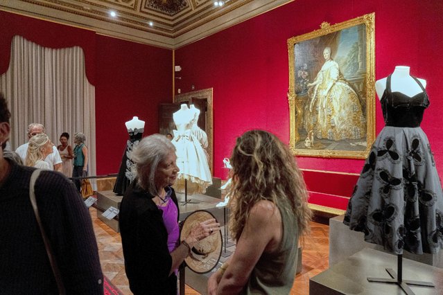 Three creations from the 1950s by, from left, Christian Dior, Yves Saint Laurent for Maison Dior, and Fernanda Gattinoni are on display at Florence's Fashion and Costume Museum in Palazzo Pitti, central Italy, Wednesday, July 16, 2025, as part of an initiative showcasing the finest fashion production of the 20th century. (Photo by Isaia Monteleone/AP Photo)