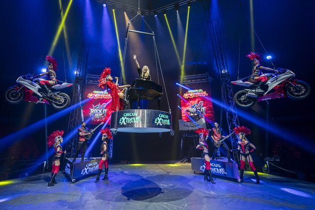 Lead choreographer at Circus Extreme, Hollie Exton, lays on the top of a piano as it is lifted towards the roof of the big-top during rehearsals, where Hollie, who has a fear of heights, visits the Circus Extreme band and dance troup members at Branksome Recreation Ground in Poole, Dorset, UK on Tuesday, July 29, 2025. (Photo by Ben Birchall/PA Wire)