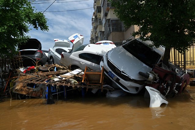 Damaged cars are seen in a flooded neighbourhood in Miyun district northern Beijing on July 29, 2025, following heavy rains. Heavy rain in Beijing killed 30 people and forced authorities to evacuate tens of thousands as swathes of northern China were lashed by torrential downpours that sparked deadly landslides, state media said on July 29. (Photo by Adek Berry/AFP Photo)