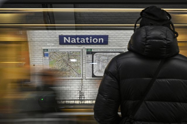A person stands at a platform of the Paris' metro station Nation renamed on All Fools' Day as “Natation” as a reference to the upcoming Paris 2024 Olympics on April 1, 2024. (Photo by Julien de Rosa/AFP Photo)